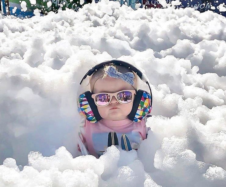 Baby with sunglasses at foam party